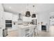 Elegant white kitchen with stainless steel appliances, large island, and pendant lighting at 5203 Title Row Dr, Bradenton, FL 34210