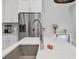 Close-up of modern island sink with view of stainless appliances in the kitchen at 5203 Title Row Dr, Bradenton, FL 34210