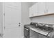 Laundry room featuring new washer and dryer, and upper cabinets for storage at 5203 Title Row Dr, Bradenton, FL 34210