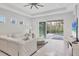 Bright living room with white tufted sofa, opens to screened lanai and pool area at 5203 Title Row Dr, Bradenton, FL 34210