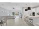 Open-concept living area with a modern kitchen, dining area, and living room at 5203 Title Row Dr, Bradenton, FL 34210