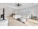View of bright living room with white tufted sofa, ceiling fan, and dining area at 5203 Title Row Dr, Bradenton, FL 34210