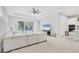 Bright living room featuring a white sectional sofa, a fan, and sliding glass doors at 5203 Title Row Dr, Bradenton, FL 34210
