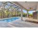 Relaxing screened-in pool with a patio, a lounge chair, and a view of green foliage at 5203 Title Row Dr, Bradenton, FL 34210