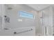 Stylish glass shower with a rain showerhead, handheld sprayer, and narrow picture window at 5203 Title Row Dr, Bradenton, FL 34210