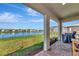 Covered back porch provides shade, along with a view of the lake and landscaped backyard at 5307 Senza Trl, Palmetto, FL 34221
