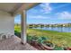 Covered back porch provides shade, along with a view of the lake and landscaped backyard at 5307 Senza Trl, Palmetto, FL 34221