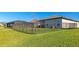 Backyard with lawn and iron fence, the perfect outdoor space for relaxation and recreation at 5307 Senza Trl, Palmetto, FL 34221