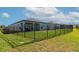 The expansive backyard, enclosed by a sleek black fence, provides a secure space for relaxation and recreation at 5307 Senza Trl, Palmetto, FL 34221