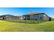 A fenced backyard shows a well-maintained lawn and screened-in pool for outdoor enjoyment and privacy at 5307 Senza Trl, Palmetto, FL 34221