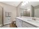 A modern bathroom features double sinks, quartz countertops, and tiled shower in a bright, clean design at 5307 Senza Trl, Palmetto, FL 34221