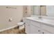 Bright bathroom features a white vanity with modern fixtures and a wood look tile floor at 5307 Senza Trl, Palmetto, FL 34221