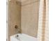 Bathroom featuring neutral tile shower/tub with light beige curtain and modern fixtures at 5307 Senza Trl, Palmetto, FL 34221