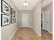 Inviting entryway with hardwood floors, neutral walls adorned with artwork, and a view into other rooms at 5307 Senza Trl, Palmetto, FL 34221