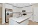Bright kitchen features white cabinets, stainless appliances, and a center island with quartz countertop at 5307 Senza Trl, Palmetto, FL 34221