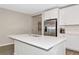 Open kitchen design showcases quartz island countertop and stainless steel refrigerator at 5307 Senza Trl, Palmetto, FL 34221