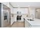 Stylish kitchen boasts stainless steel appliances, white cabinets, and sleek countertops at 5307 Senza Trl, Palmetto, FL 34221