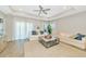 Bright living room with tray ceiling, white sofas, and oversized rug for comfortable living at 5307 Senza Trl, Palmetto, FL 34221