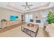 Comfortable living room features ceiling fan, neutral color palette, and entertainment center at 5307 Senza Trl, Palmetto, FL 34221