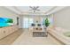 Cozy living room features tray ceiling, light-filled windows, and comfortable seating area at 5307 Senza Trl, Palmetto, FL 34221
