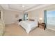 Spacious bedroom features a tray ceiling, neutral tones, large windows, and comfortable furnishings at 5307 Senza Trl, Palmetto, FL 34221