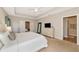 A serene bedroom with neutral tones, carpet, a dresser, and an ensuite bathroom for added privacy at 5307 Senza Trl, Palmetto, FL 34221