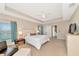 A bright bedroom with tray ceilings, carpet, ample natural light, and a doorway to another room at 5307 Senza Trl, Palmetto, FL 34221