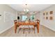 Open-concept home with dining area, living room and neutral paint throughout creates a seamless flow at 5307 Senza Trl, Palmetto, FL 34221