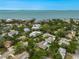 Aerial shot of waterfront neighborhood with bay views and lush, mature trees, surrounded by other upscale homes at 577 Corwood Dr, Sarasota, FL 34234