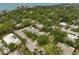 An aerial view of a neighborhood, showcasing houses with green landscaping and a glimpse of the bay at 577 Corwood Dr, Sarasota, FL 34234