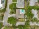 Aerial view of a home with a pool and lush landscaping, nestled in a residential neighborhood at 577 Corwood Dr, Sarasota, FL 34234