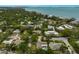 Aerial shot of a bay neighborhood with bay views and lush, mature trees, surrounded by upscale homes at 577 Corwood Dr, Sarasota, FL 34234