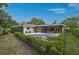 Wide angle view of backyard featuring pool, patio, and lush landscaping at 577 Corwood Dr, Sarasota, FL 34234