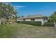 Spacious backyard with manicured lawn and lush perimeter landscaping at 577 Corwood Dr, Sarasota, FL 34234
