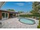 Backyard pool with adjacent covered seating area and lush greenery at 577 Corwood Dr, Sarasota, FL 34234