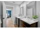 Well-lit bathroom with double vanity sinks and modern fixtures, showcasing a clean design with easy access to bedroom at 577 Corwood Dr, Sarasota, FL 34234