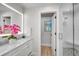 Elegant bathroom featuring a double vanity, marble countertop, and glass-enclosed shower with designer tile work at 577 Corwood Dr, Sarasota, FL 34234