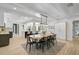Bright dining area with an attractive wood table, modern lighting, and seamless flow to other living areas at 577 Corwood Dr, Sarasota, FL 34234