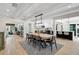 Open-concept dining room with wood table, modern light fixture, and views into the kitchen and living spaces at 577 Corwood Dr, Sarasota, FL 34234