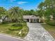 Beautifully landscaped home with stone driveway and a well-manicured lawn at 577 Corwood Dr, Sarasota, FL 34234