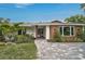 Exterior front facade features mid-century modern architecture with landscaped grounds at 577 Corwood Dr, Sarasota, FL 34234