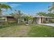 Single-story home with lush landscaping and well-manicured front lawn at 577 Corwood Dr, Sarasota, FL 34234