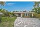 Charming single-story home with brick driveway and lush landscaping at 577 Corwood Dr, Sarasota, FL 34234