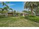 Lush lawn and landscaping frame this charming single-story home at 577 Corwood Dr, Sarasota, FL 34234