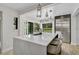 Open-concept kitchen with island seating, stainless steel appliances, and seamless access to the outdoor pool area at 577 Corwood Dr, Sarasota, FL 34234