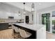 Modern kitchen with a large island, pendant lighting, and stainless steel appliances, perfect for entertaining at 577 Corwood Dr, Sarasota, FL 34234