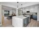 Open kitchen with island seating, stainless steel appliances, and view of dining area at 577 Corwood Dr, Sarasota, FL 34234
