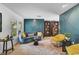 Stylish living room features a blue velvet sofa, decorative wall paneling, open bookshelves, and hardwood floors at 577 Corwood Dr, Sarasota, FL 34234