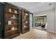 Stylish living room featuring dark wood bookshelves and an open view to the screened in patio at 577 Corwood Dr, Sarasota, FL 34234