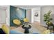 Stylish living room features two yellow chairs, decorative wall paneling, and hardwood floors at 577 Corwood Dr, Sarasota, FL 34234